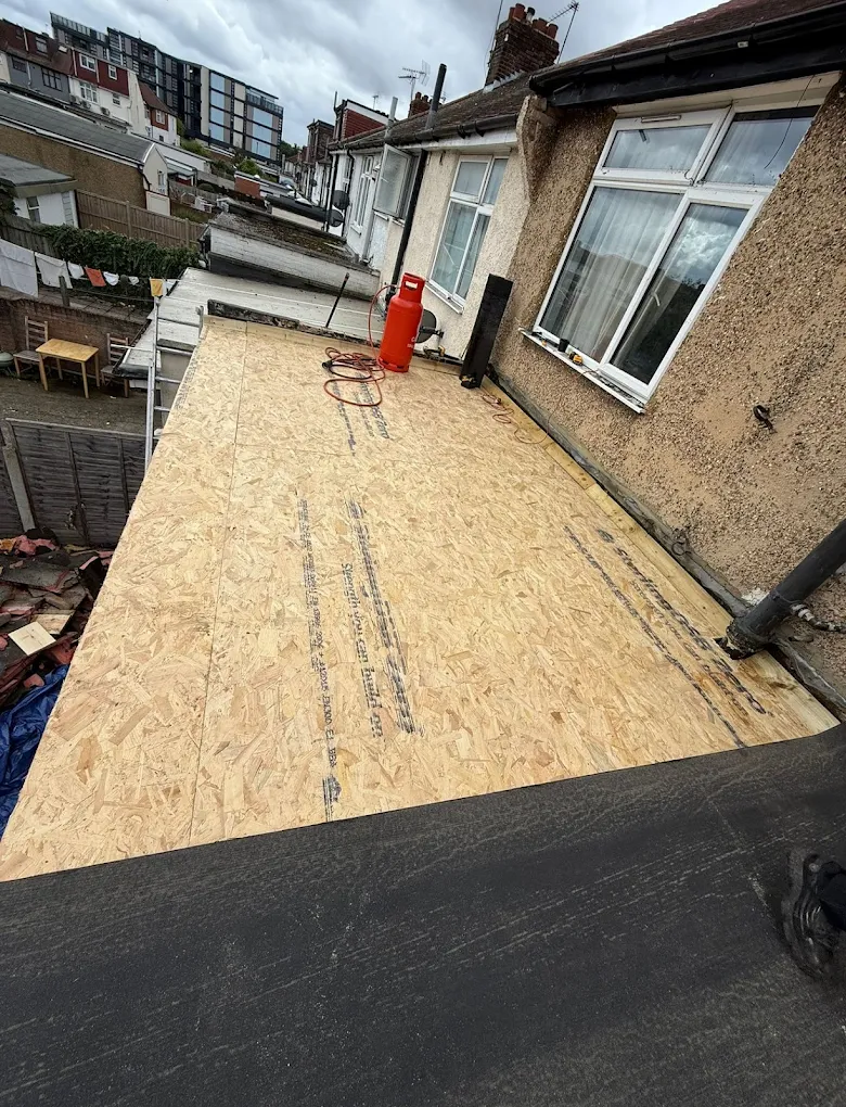flat roofers repairing a roof